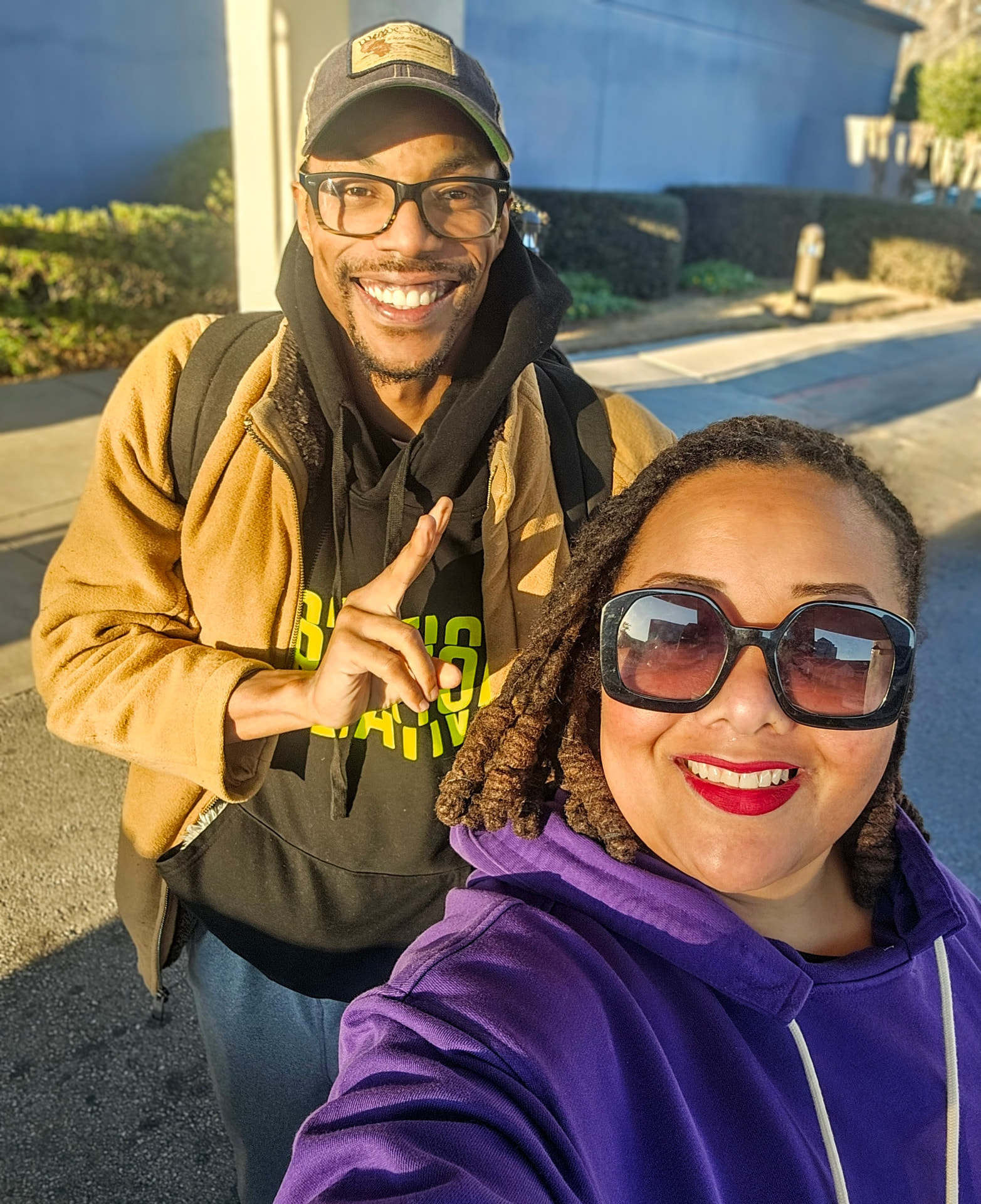 Geo Dixon and Madison Sinclair standing together outside in golden-hour light