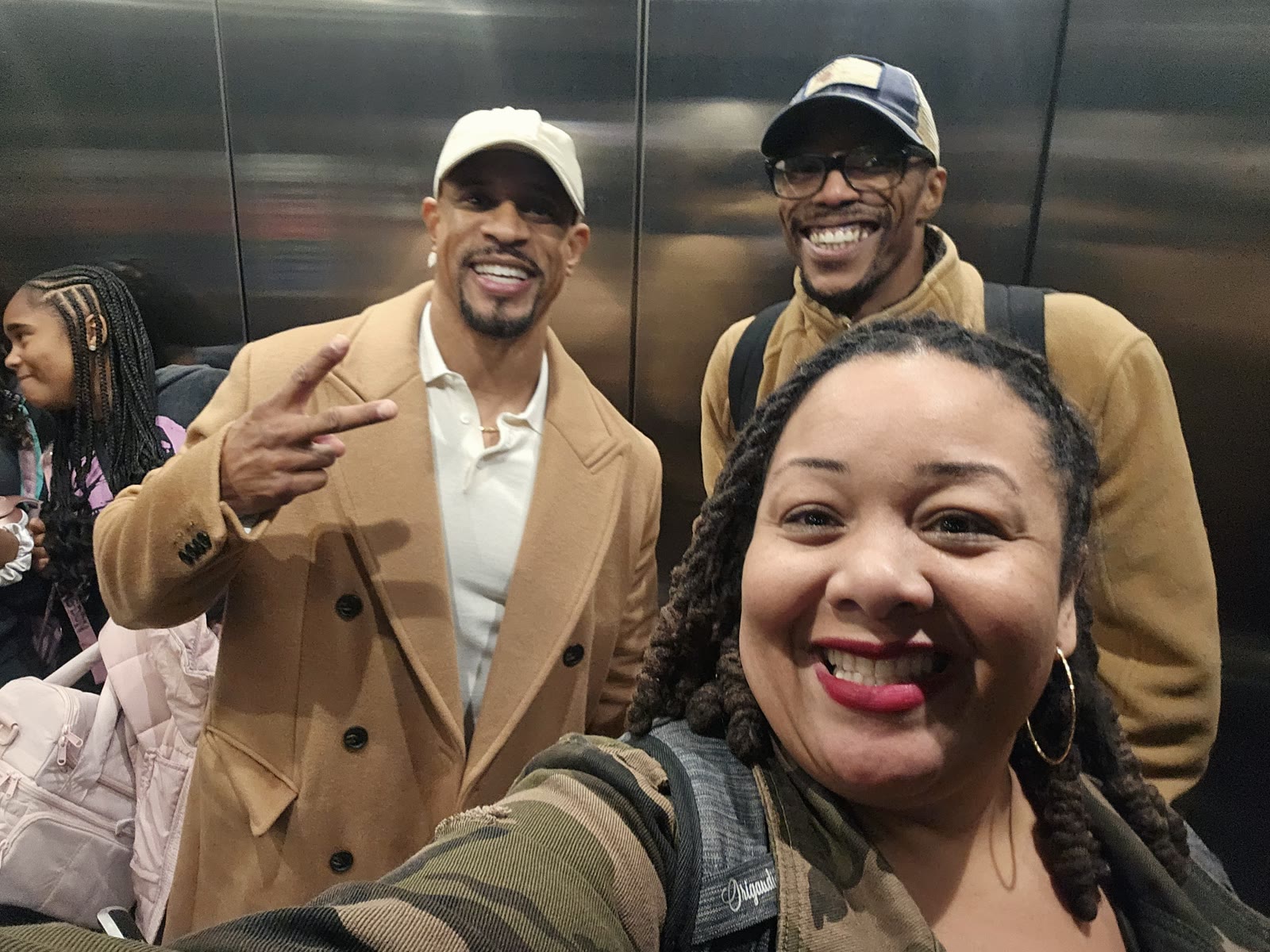Madison Sinclair, Geo Dixon and a fellow speaker laughing together in an elevator at a conference